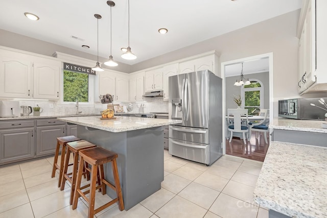3300 Chancellor Ln, Monroe, NC 28110 - kitchen featuring stainless steel appliances, gray cabinets, under cabinet range hood, healthy amount of natural light, and recessed lighting