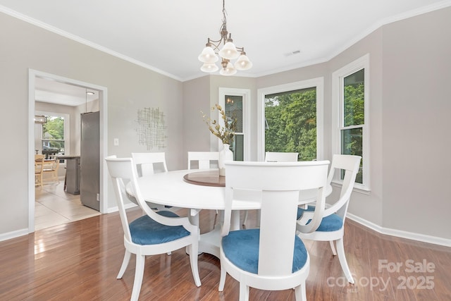 3300 Chancellor Ln, Monroe, NC 28110 - dining area with a chandelier, baseboards, ornamental molding, and wood finished floors