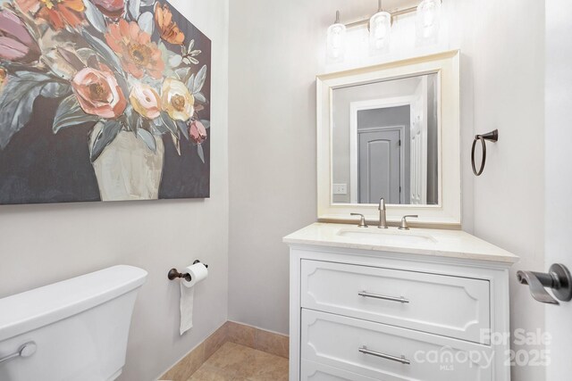 3300 Chancellor Ln, Monroe, NC 28110 - half bathroom with toilet, vanity, and baseboards