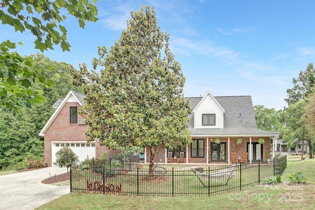 3300 Chancellor Ln, Monroe, NC 28110 - view of front of house with brick siding, driveway, a fenced front yard, an attached garage, and covered porch
