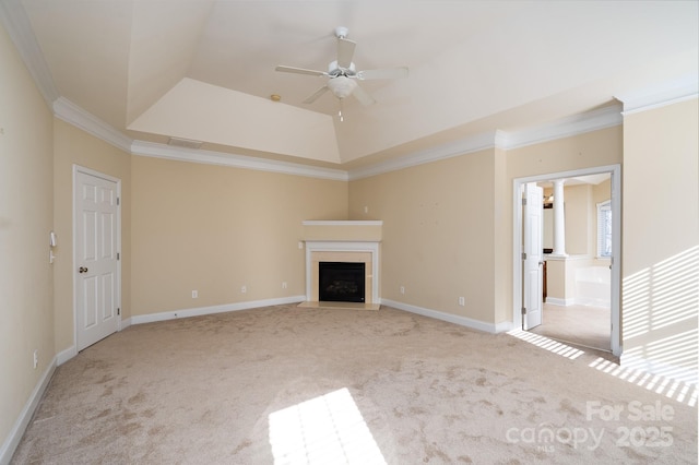 unfurnished living room with crown molding, light colored carpet, a raised ceiling, and ceiling fan