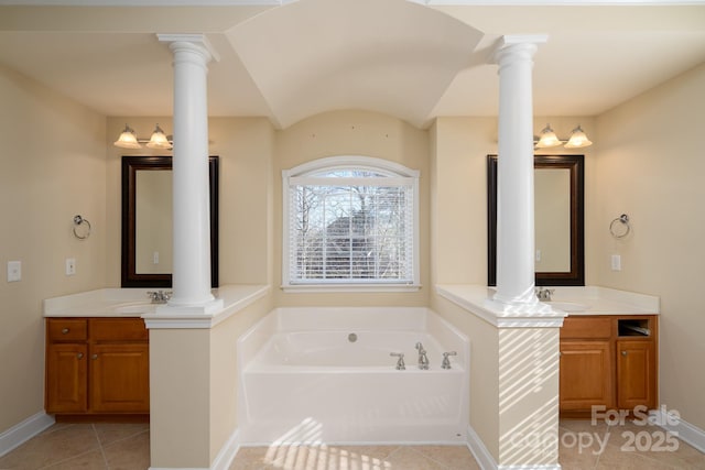 bathroom with vanity, a washtub, decorative columns, and tile patterned floors