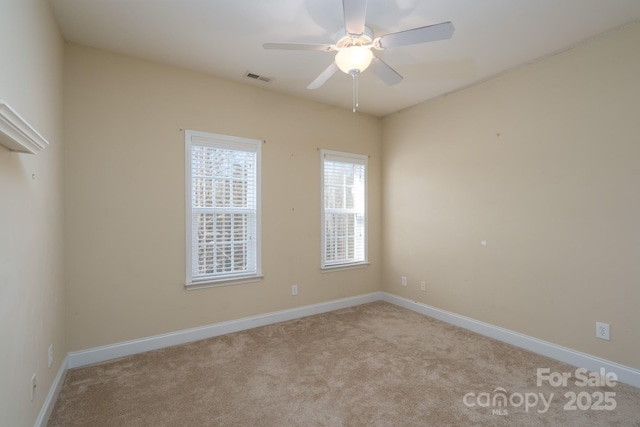 unfurnished room with ceiling fan and light carpet