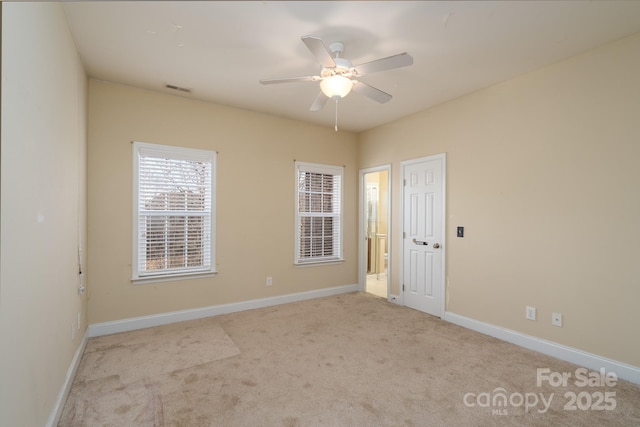 empty room featuring light carpet and ceiling fan