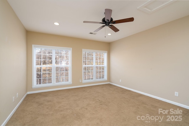 carpeted spare room with ceiling fan