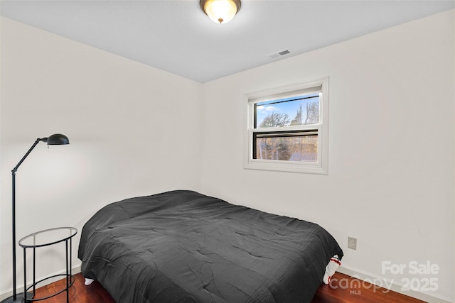 bedroom featuring dark wood-type flooring