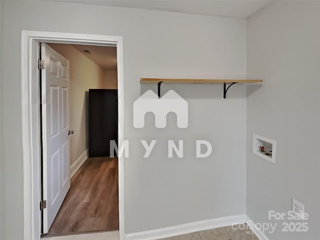 laundry room featuring washer hookup and light hardwood / wood-style floors