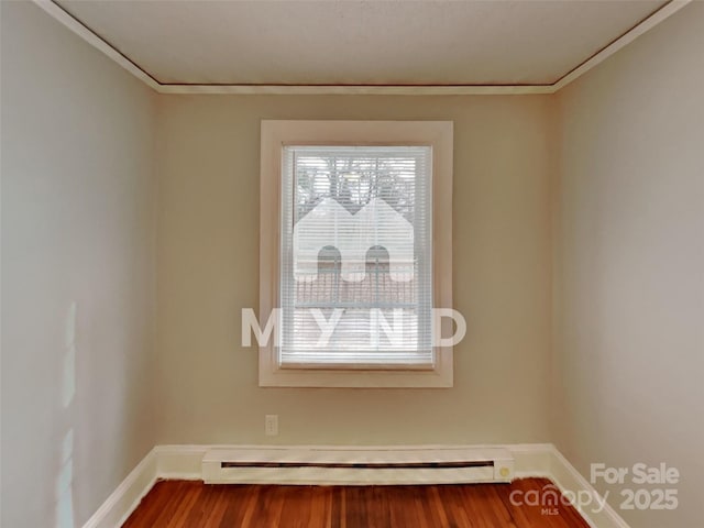 room details featuring a baseboard radiator, ornamental molding, and hardwood / wood-style floors