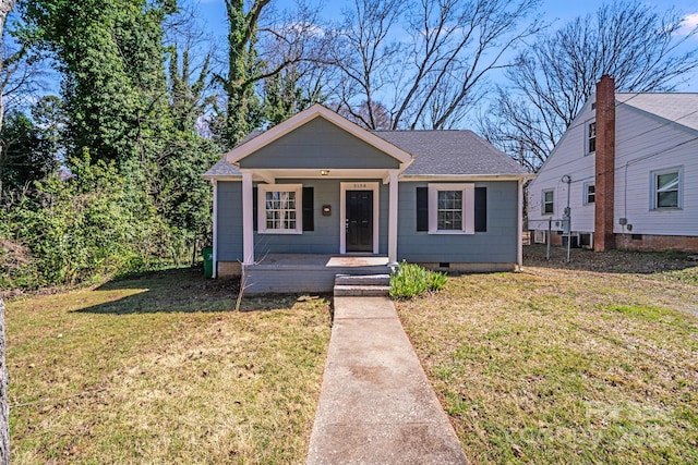 bungalow-style home featuring crawl space, a porch, a front lawn, and roof with shingles