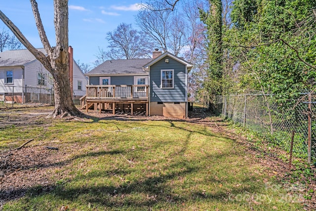 rear view of house with a wooden deck, a fenced backyard, a chimney, crawl space, and a lawn