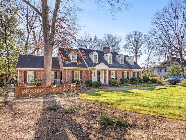 cape cod home with a front yard