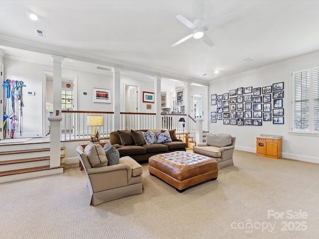 carpeted living room with ceiling fan, ornamental molding, and decorative columns