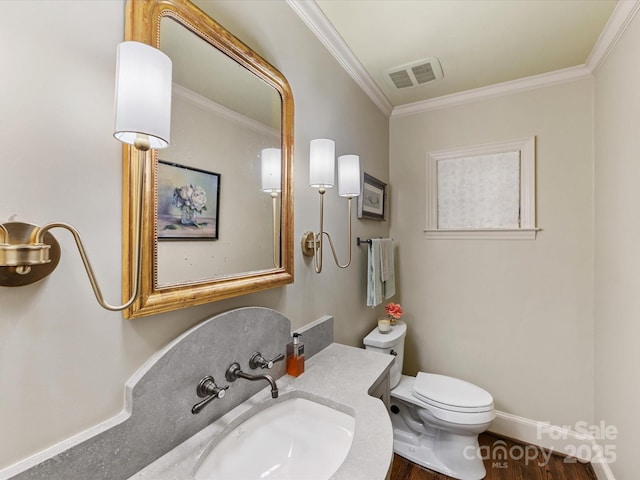 bathroom with ornamental molding, wood-type flooring, vanity, and toilet