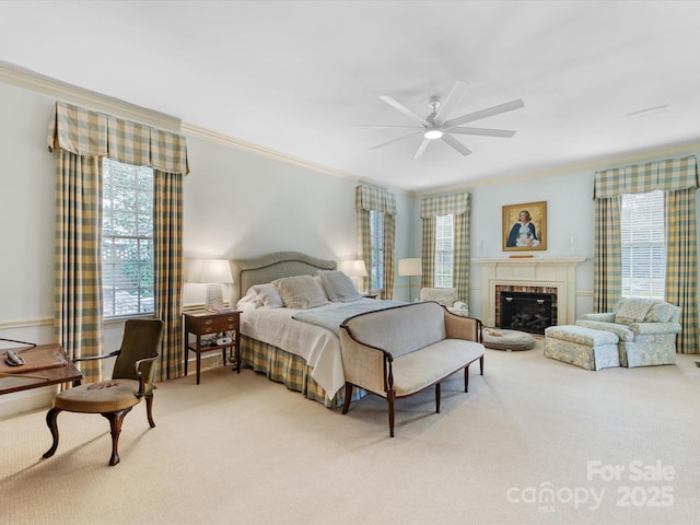 bedroom with ornamental molding, a brick fireplace, carpet floors, and ceiling fan