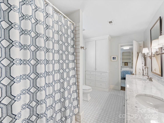 bathroom with walk in shower, vanity, toilet, and tile patterned flooring