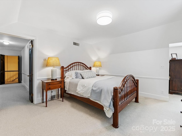 carpeted bedroom with vaulted ceiling