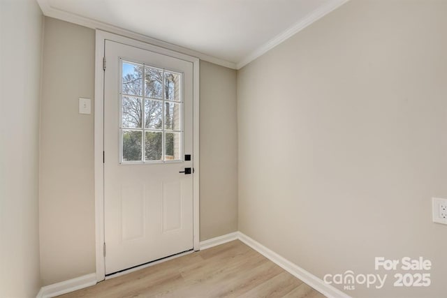 doorway featuring ornamental molding and light wood-type flooring