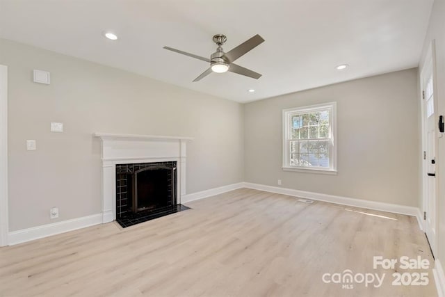 unfurnished living room with ceiling fan and light hardwood / wood-style flooring