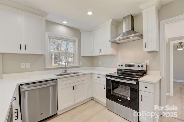 kitchen featuring wall chimney exhaust hood, white cabinetry, and stainless steel appliances