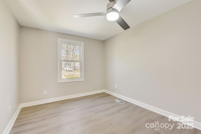 empty room with ceiling fan and light wood-type flooring