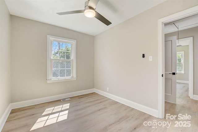 unfurnished room featuring plenty of natural light, light hardwood / wood-style floors, and ceiling fan