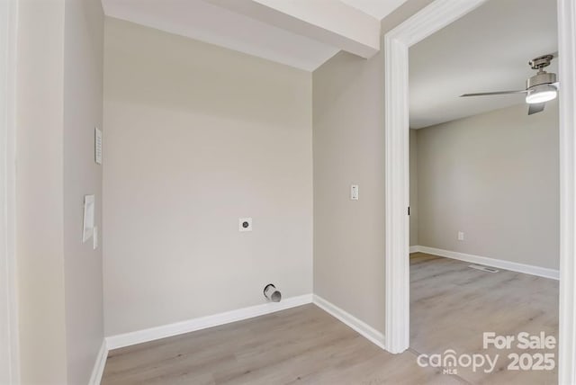 laundry area featuring hookup for an electric dryer, ceiling fan, and light wood-type flooring