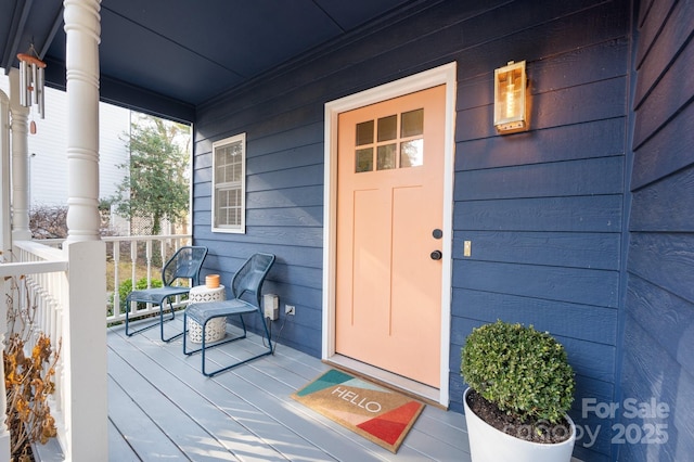 entrance to property featuring covered porch