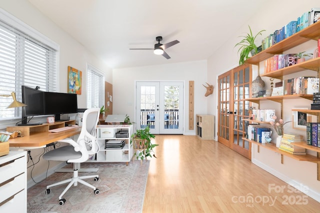 office space featuring french doors, ceiling fan, and light hardwood / wood-style floors