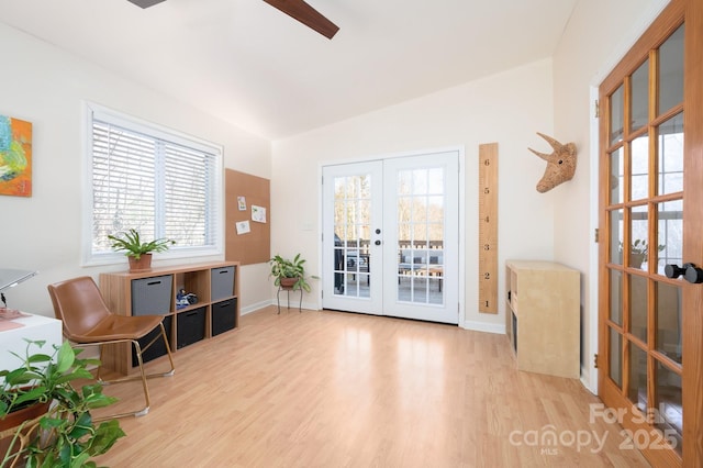 sitting room featuring vaulted ceiling, ceiling fan, light hardwood / wood-style floors, and french doors