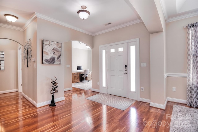 foyer with crown molding and wood-type flooring