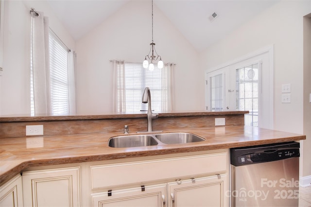 kitchen with pendant lighting, sink, stainless steel dishwasher, and cream cabinetry