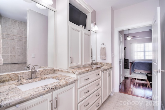 bathroom with ceiling fan, vanity, and tile patterned flooring