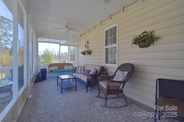 sunroom / solarium featuring ceiling fan