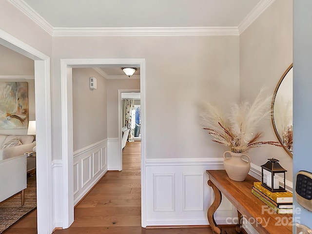 hallway featuring crown molding and hardwood / wood-style floors