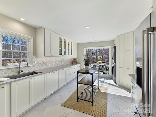 kitchen featuring white cabinetry, sink, and backsplash