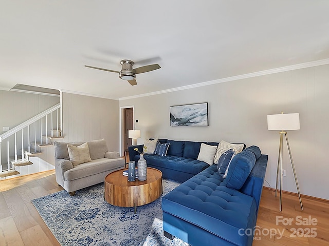 living room featuring hardwood / wood-style flooring, ornamental molding, and ceiling fan