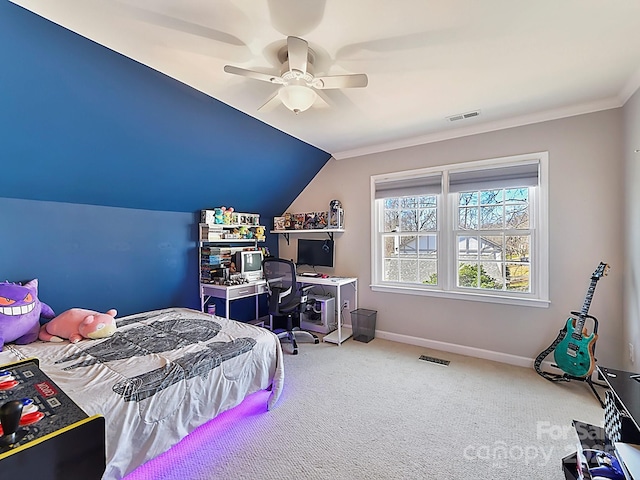 bedroom featuring lofted ceiling, ornamental molding, ceiling fan, and carpet flooring