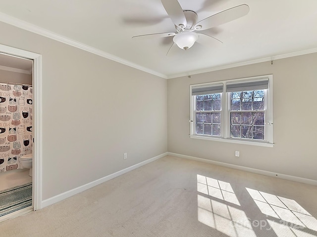 carpeted empty room featuring crown molding and ceiling fan