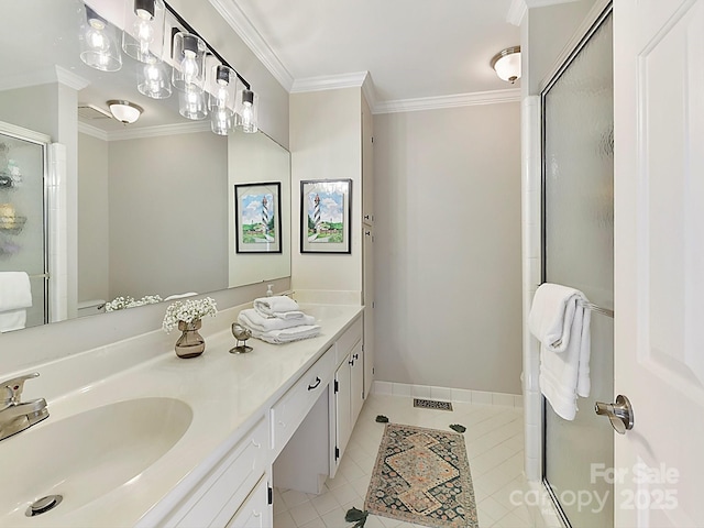 bathroom featuring ornamental molding, a shower with door, tile patterned flooring, and vanity