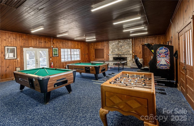 game room with wooden walls, pool table, dark carpet, wooden ceiling, and french doors