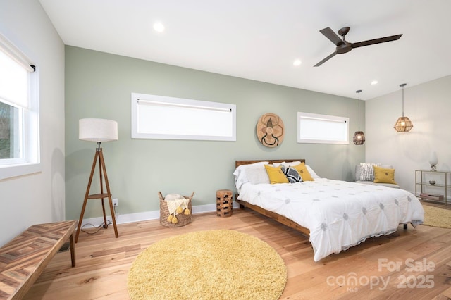 bedroom featuring ceiling fan and light hardwood / wood-style flooring