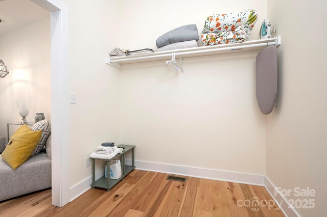 spacious closet with hardwood / wood-style flooring