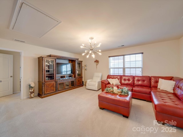 living room featuring a chandelier and carpet flooring