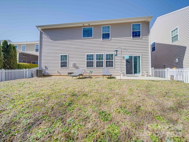 rear view of property with a patio, a yard, and central air condition unit