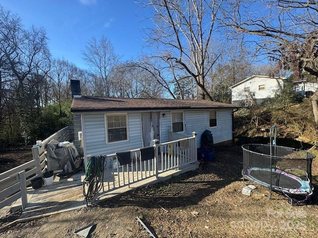 view of front of property featuring a deck and a trampoline