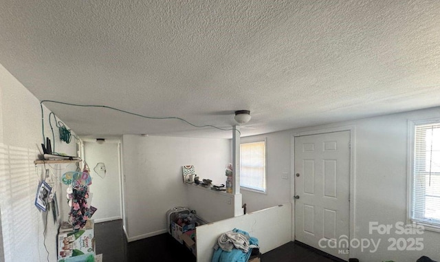 interior space with a textured ceiling