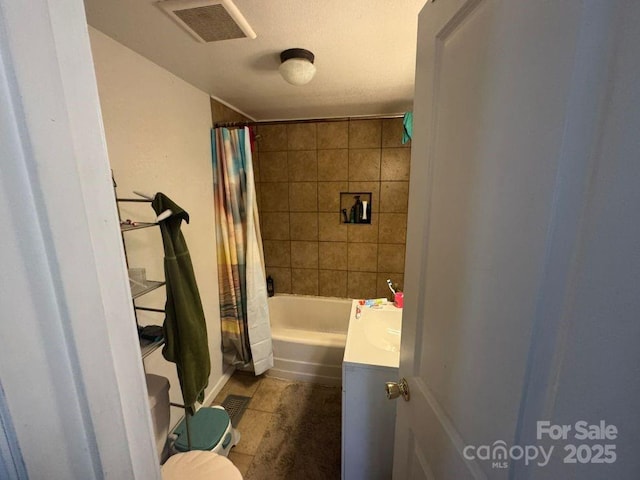 full bathroom with shower / bathtub combination with curtain, vanity, and toilet