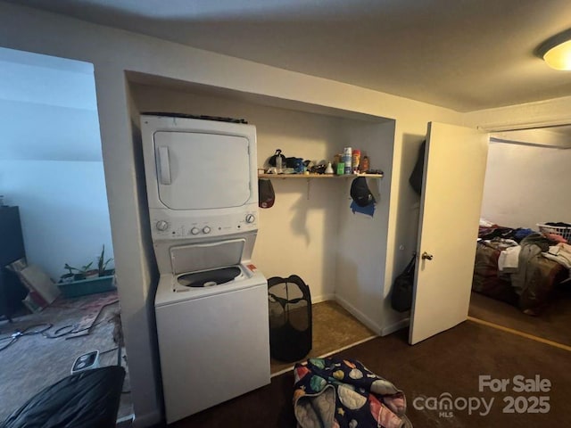 laundry area featuring stacked washer / drying machine