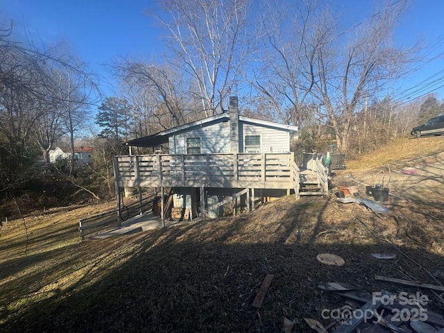 rear view of house featuring a deck