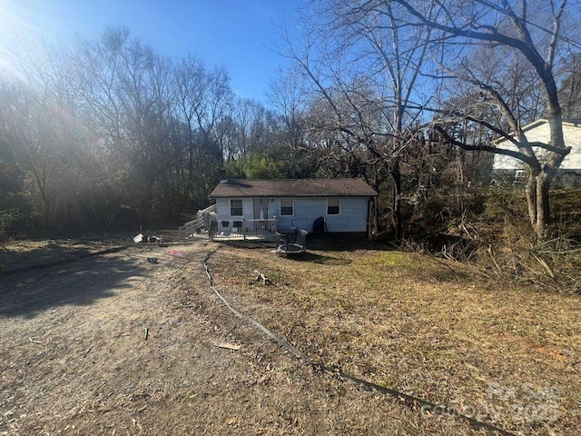 rear view of property featuring a wooden deck